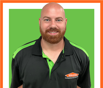 Cory, servpro employee against a green background, man