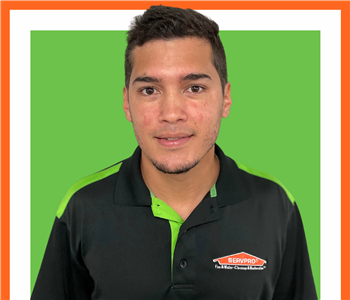 Eduardo, male, SERVPRO employee against a white background and green SERVPRO logo